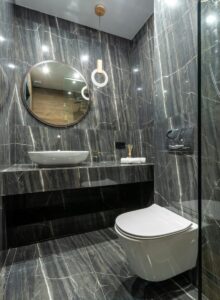 Luxurious bathroom interior featuring sleek marble walls, floating sink, and a contemporary toilet design.