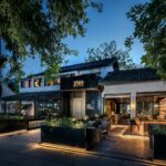 lighted house beside trees