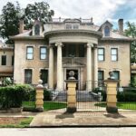 gray concrete pillared building surrounded by trees during daytime